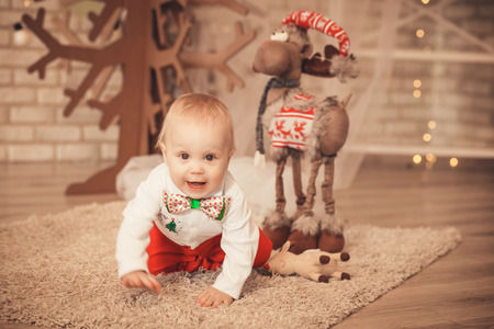handsome little baby boy among Christmas decorationsの写真素材