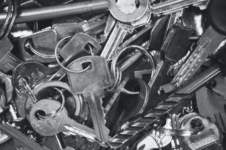 A Pile of old Keys different shapes and colors. Many vintage keys. Black and white photography