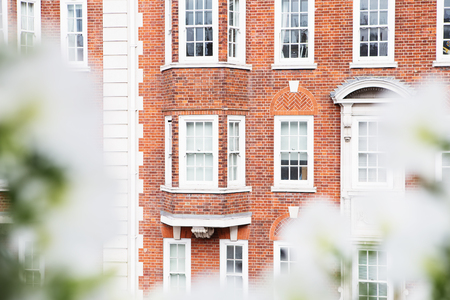 White vintage wooden windows on a restored red brick wallの写真素材