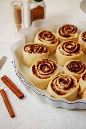 Cinnabon buns. Raw Cinnamon rolls in a baking dish before bakingの写真素材
