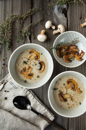Two bowls with delicious mushroom soup on wooden table. flat lay composition.の写真素材