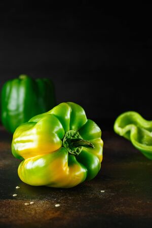 Sweet green pepper on dark background. Fresh yellow green bell pepper (capsicum)の写真素材
