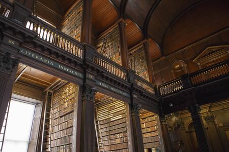 Dublin, Ireland - June 24, 2019: The Long Room interior Of The Old Library At Trinity College. Marble busts of great people and shelves with antique tomesのeditorial素材