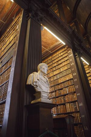 Dublin, Ireland - June 24, 2019: The Long Room interior Of The Old Library At Trinity College. Marble busts of great people and shelves with antique tomesのeditorial素材