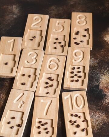 Wooden counting and writing trays - learning resource for educating littles on number writing, fine motor skills, hand eye coordination, mathematical skills. Montessori materials. Counting math gameの写真素材