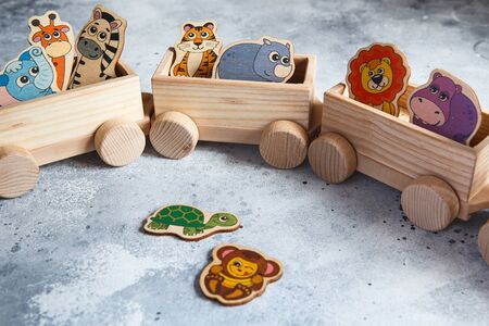 Children's wooden toys. Children wooden train with wagons. Natural wood construction set. Educational equipment. Noah's Arkの写真素材