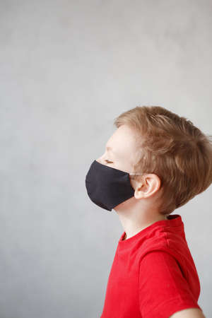 Little boy wearing a mask against corona virus covid-19, 2019-nCov. Kid in a surgical bandage or respirator during corona virus and flu outbreak. Child in a medical mask. Coronavirus quarantine.の写真素材