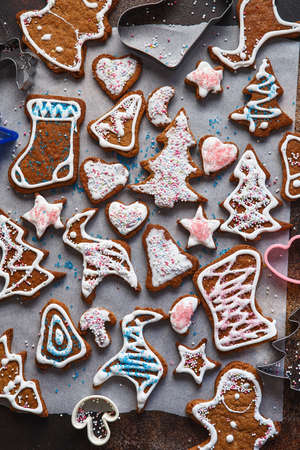 Christmas homemade gingerbread cookies. Clazed decorating gingerbread homemade cookies for christmas. Top view of cookies on table, Happy new year, celebration, overhead, top view, flat layの写真素材