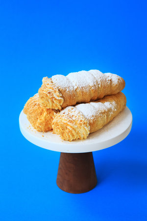 sweet rolls with butter cream on the blue backgroundの写真素材
