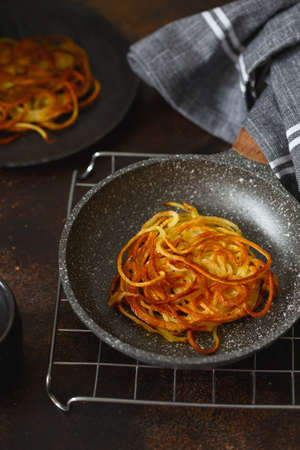 Hash brown potato in a small frying pan. Potato Pancakes. delicious Vegetable fritters. Potato patties or hash browns. Crispy hashed browned potatoesの写真素材