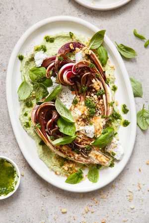 roasted radicchio salad with feta, green tahini, Pine nuts and basil pesto. Radicchio rosso di...