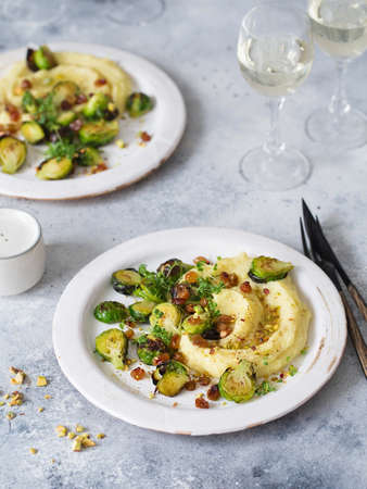 Brussels sprouts with pistachios, raisins and Skordalia (mashed potatoes). Healthy Meal preparation. Plant-based dishes. Green living. Vegan recipe. Food styling. Vegetarian cuisine. Healthy eatingの写真素材