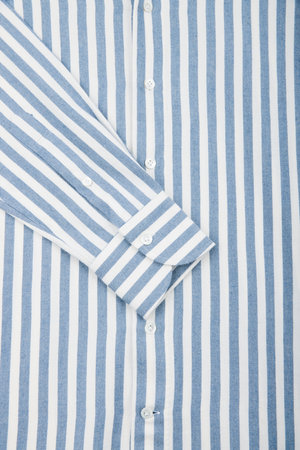 Striped men's shirt. Sleeve close up. White and blue striped fabric texture backgroundの写真素材