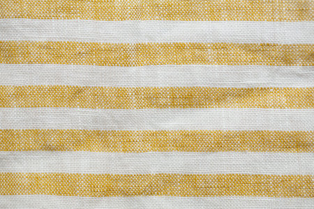 Yellow and white striped fabric with a rustic, woven texture. A seamless, natural pattern ideal for...
