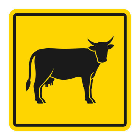 Warning sign for cattle on the road. Silhouette of cow on yellow background. Vector illustrationのイラスト素材
