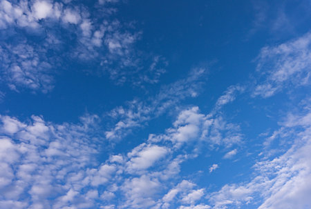 White tiny clouds in blue sky background