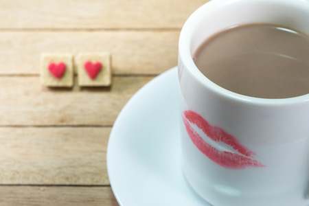 Ceramic coffee cup with lipstick mark on wood backgroundの写真素材