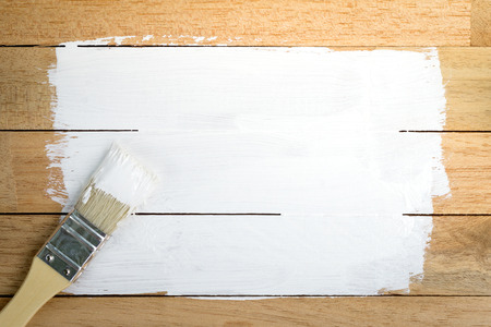 White paint space with paintbrush on wood backgroundの写真素材