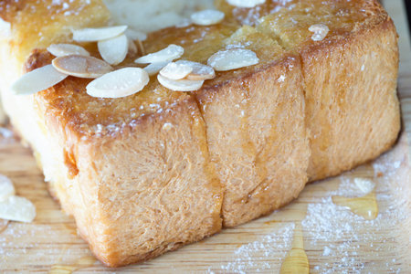 Honey toast with syrup and sliced almonds