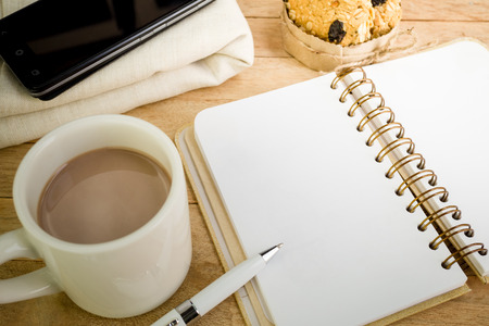 Blank notebook with coffee  on wood backgroundの写真素材