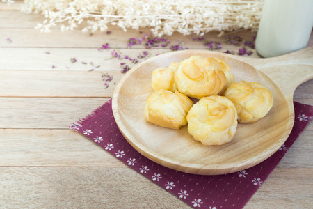 Vanilla cream eclairs on wood tableの写真素材