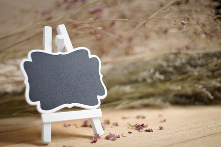 Blank chalkboard frame and stand on wood backgroundの写真素材