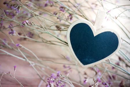 Blank wooden frame  with dried flower bouquet backgroundの写真素材