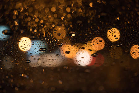 Raindrops on window grass at nightの写真素材
