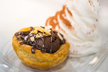 Brownie tart with sliced almond and vanilla ice cream 