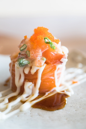 Salmon sashimi rolls with cream and flying fish roe
の写真素材