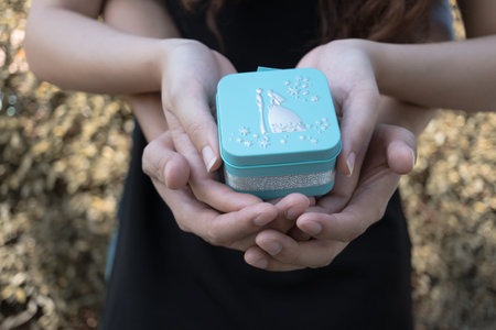 Lovers couple holding  blue gift box  for wedding and love concept