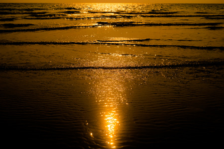Sunset light shimmering  water surface on tropical beach
の写真素材