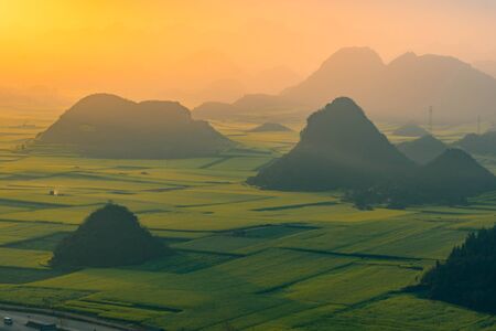 Small villages with Rapeseed flowers at Jinjifeng(Golden Chicken Peak), Chinaの写真素材