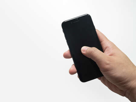 hand holding smartphone isolated on white.の写真素材