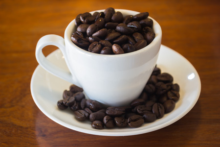 Coffee Cup or Coffee Beans on wooden table, stock photoの写真素材