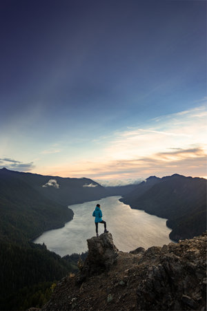 This is the picture of Female Hiker Standing on the Top of Mount Storm King National Park.の写真素材