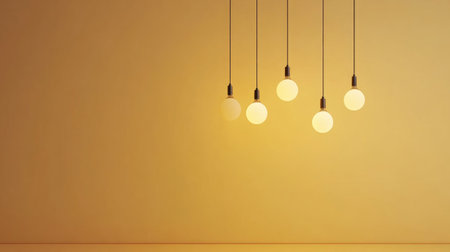This image features five elegant pendant lights hanging against a minimalist yellow wall, creating a warm and inviting atmosphere perfect for modern interior designs.の素材