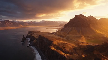 Breathtaking aerial view showcasing towering mountains and tranquil waters illuminated by the warm hues of sunset, capturing nature's serene beauty.の素材