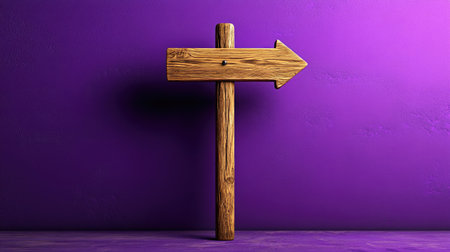 A rustic wooden directional signpost with an arrow pointing right, set against a bright purple wall, evokes feelings of guidance and creativity.の素材