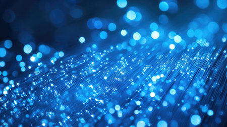 Captivating blue light bokeh creates a mesmerizing atmosphere, featuring glowing particles and soft sparkles for an enchanting abstract background.の素材