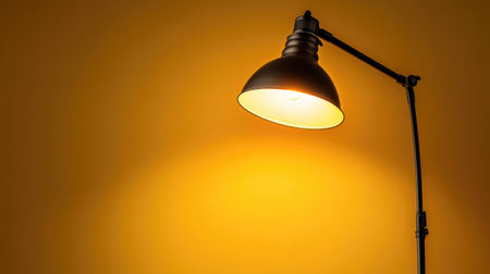 This image showcases an elegant floor lamp casting warm light against a vibrant yellow wall, creating a cozy and inviting atmosphere for any interior space.の素材