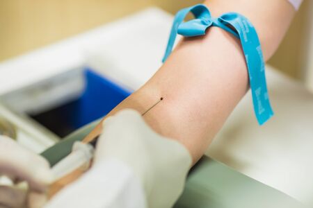 Medical technologist doing a blood draw services for patient.の写真素材