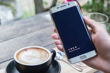 CHIANG MAI,THAILAND - NOV 20,2015 : A man hand holding Uber app welcome screen showing on Samsung...