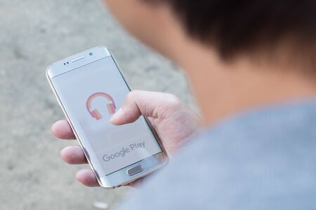 CHIANGMAI, THAILAND -NOV 28, 2015, A man hand holding screen shot of google play music . Google play...
