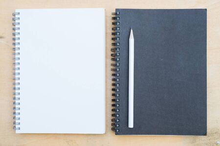 Notebook and pencil on deskの写真素材