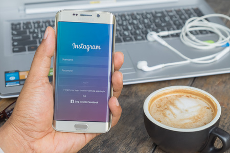 CHIANG MAI, THAILAND - MAR 09, 2016: A man hand holding screen shot of Instagram application using samsung galaxy s6 edge. Instagram is largest and most popular photograph social networking.のeditorial素材