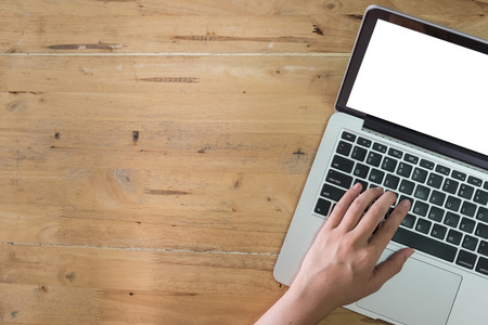 Business woman using laptop on wooden desk. top view with copy spaceの写真素材