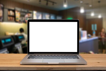 Laptop with blank screen on table.