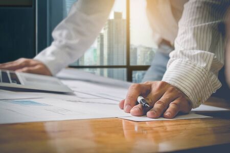 Business partners discussing documents and ideas at meeting with vintage retro filterの写真素材