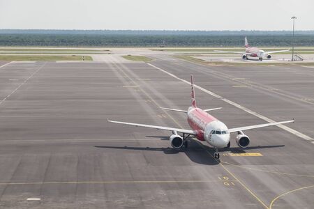KUALA LUMPUR, MALAYSIA - SEP 4, 2016 - AirAsia flight in the airport. AirAsia Berhad is a Malaysian low-cost airline headquartered near Kuala Lumpur, Malaysiaのeditorial素材